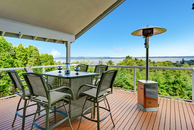 Modern outdoor patio heater in custom deck seating area, overlooking backyard view.